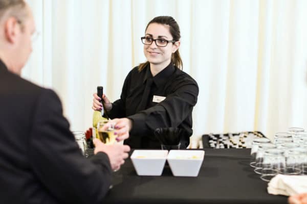 Emily, nuphoriq's graphic designer, bartending an event