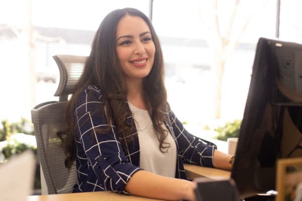 nuphoriq's Social Media Director working at her desk